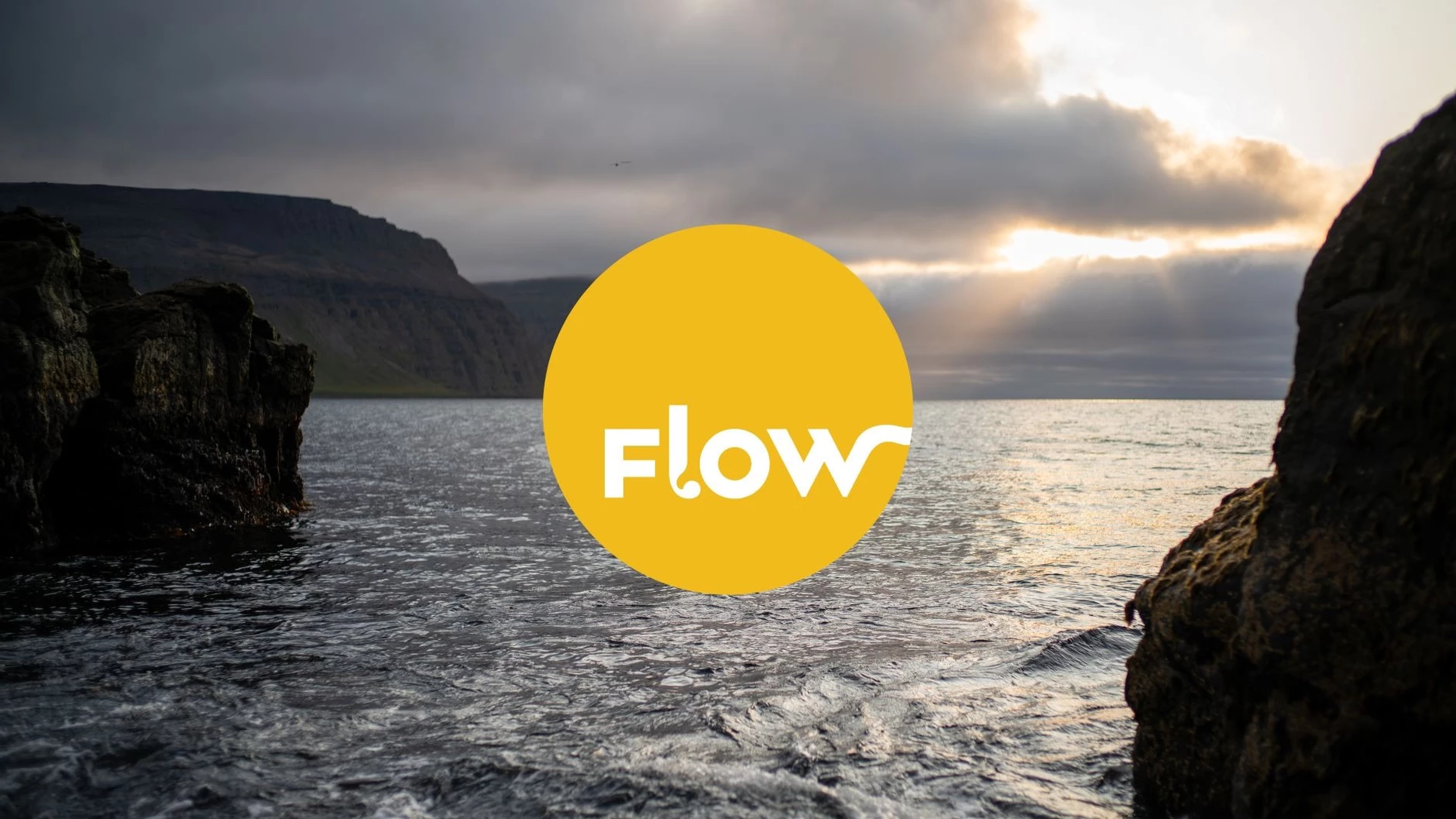 Flow logo with an Icelandic coast sunset in the background