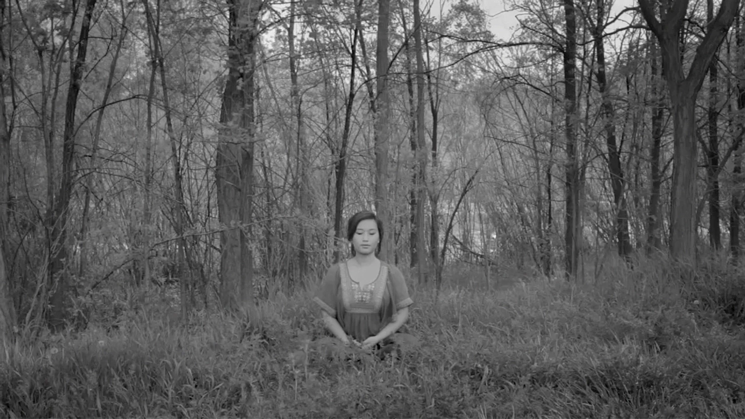 A person meditating in nature