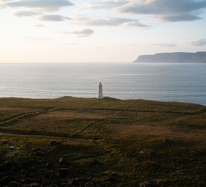 A lighthouse on the edge of a cliff in Iceland