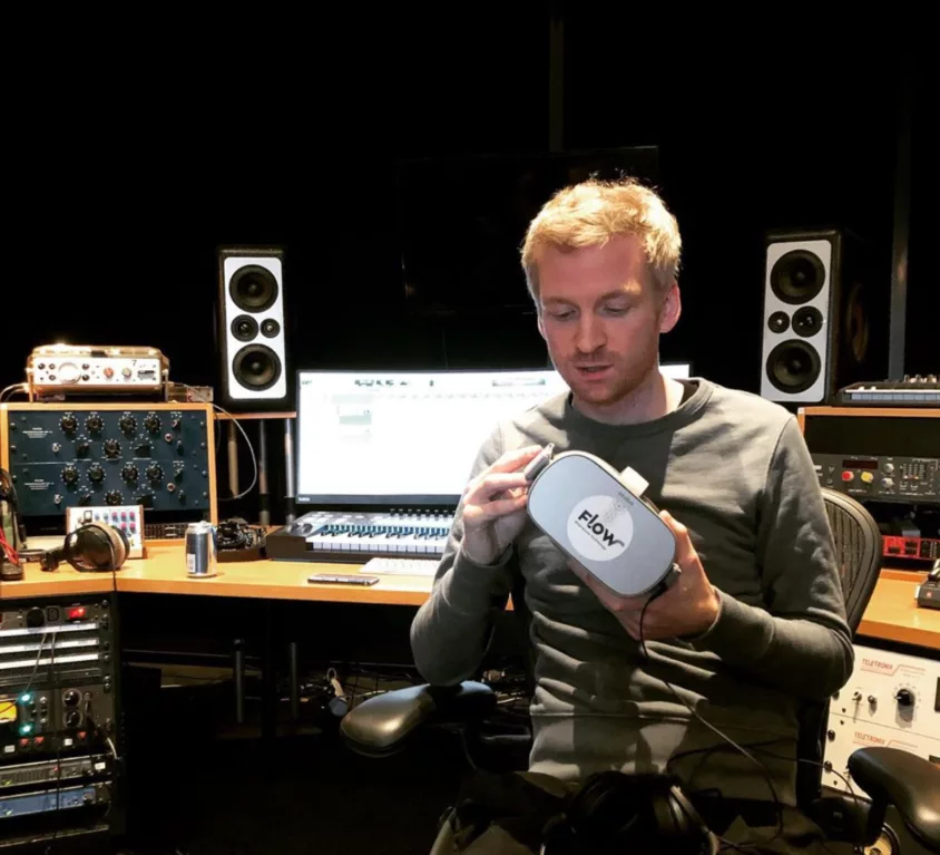 ólafur Arnalds holding a Flow headset