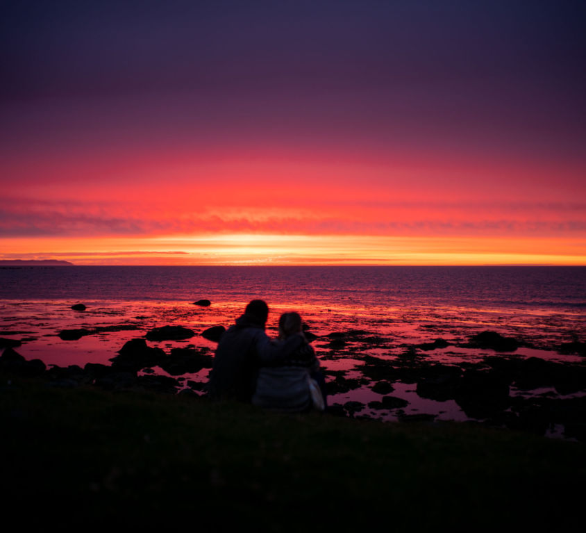 image of a couple at a red sunset in Iceland